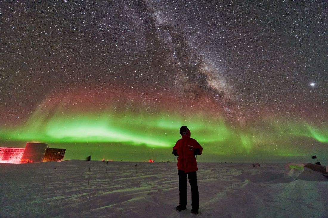 Ben silhouetted by the Northern Lights in Antarctica