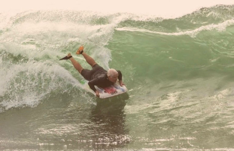 Pat O. driving hard into a green curling wave on his custom Warpmat surf mat